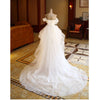 The Bride'S Wedding Dress With Long Tail In Front Of The Studio