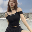 Pleated skirt with letter straps