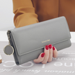 Women's hand holding wallet female long section 2021 new Japanese and Korean personality pendant multi-function student wallet