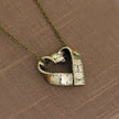 Heart-shaped rotating tape measure necklace