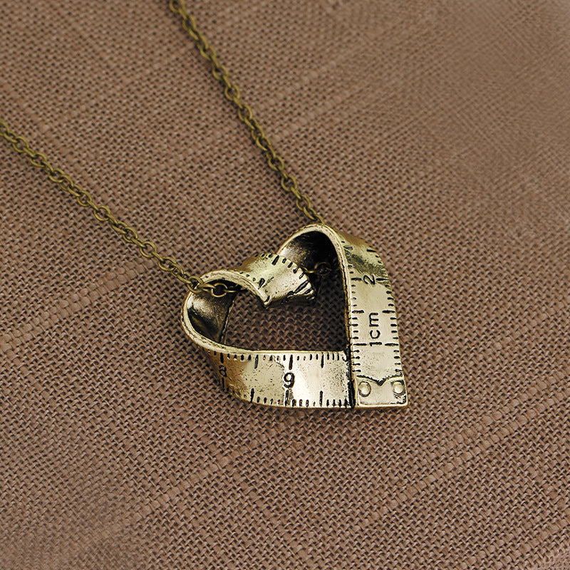 Heart-shaped rotating tape measure necklace