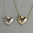 Heart-shaped rotating tape measure necklace