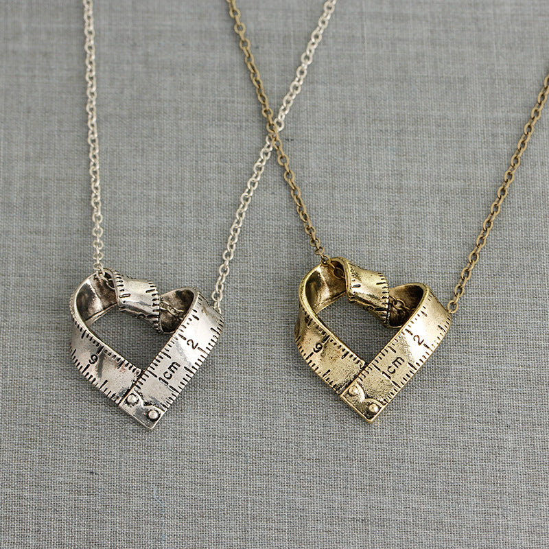 Heart-shaped rotating tape measure necklace