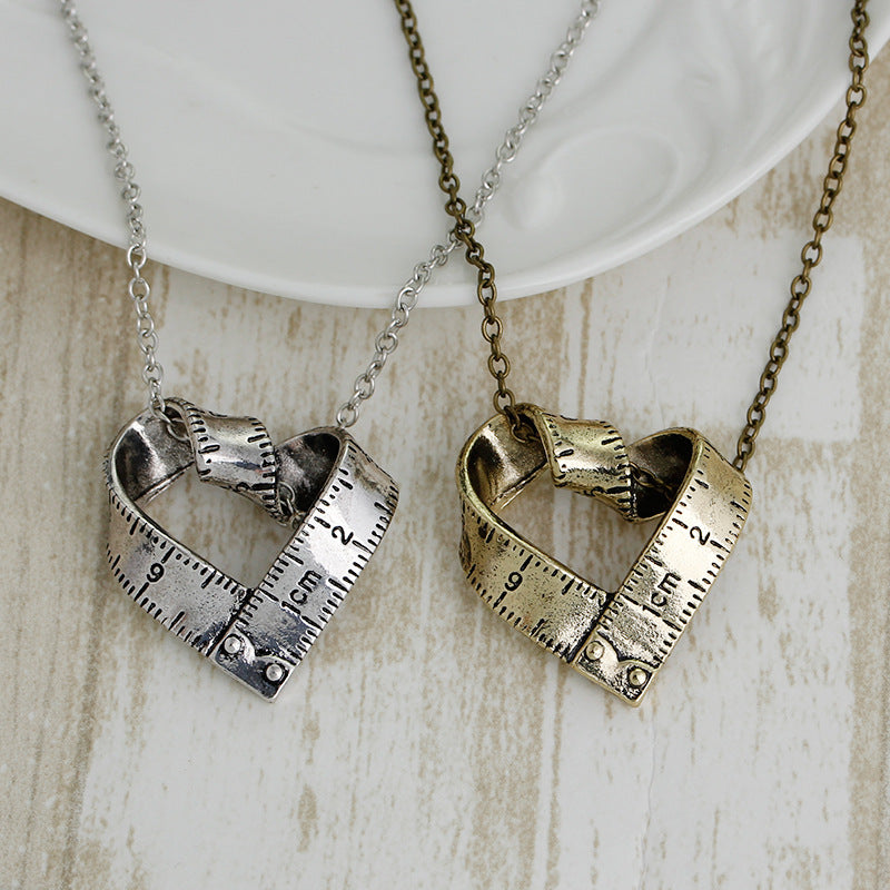 Heart-shaped rotating tape measure necklace